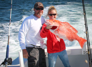 father and daughter fishing trip with a caught redsnapper